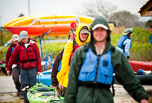 Coastal Restoration Volunteers Unloading Kayaks